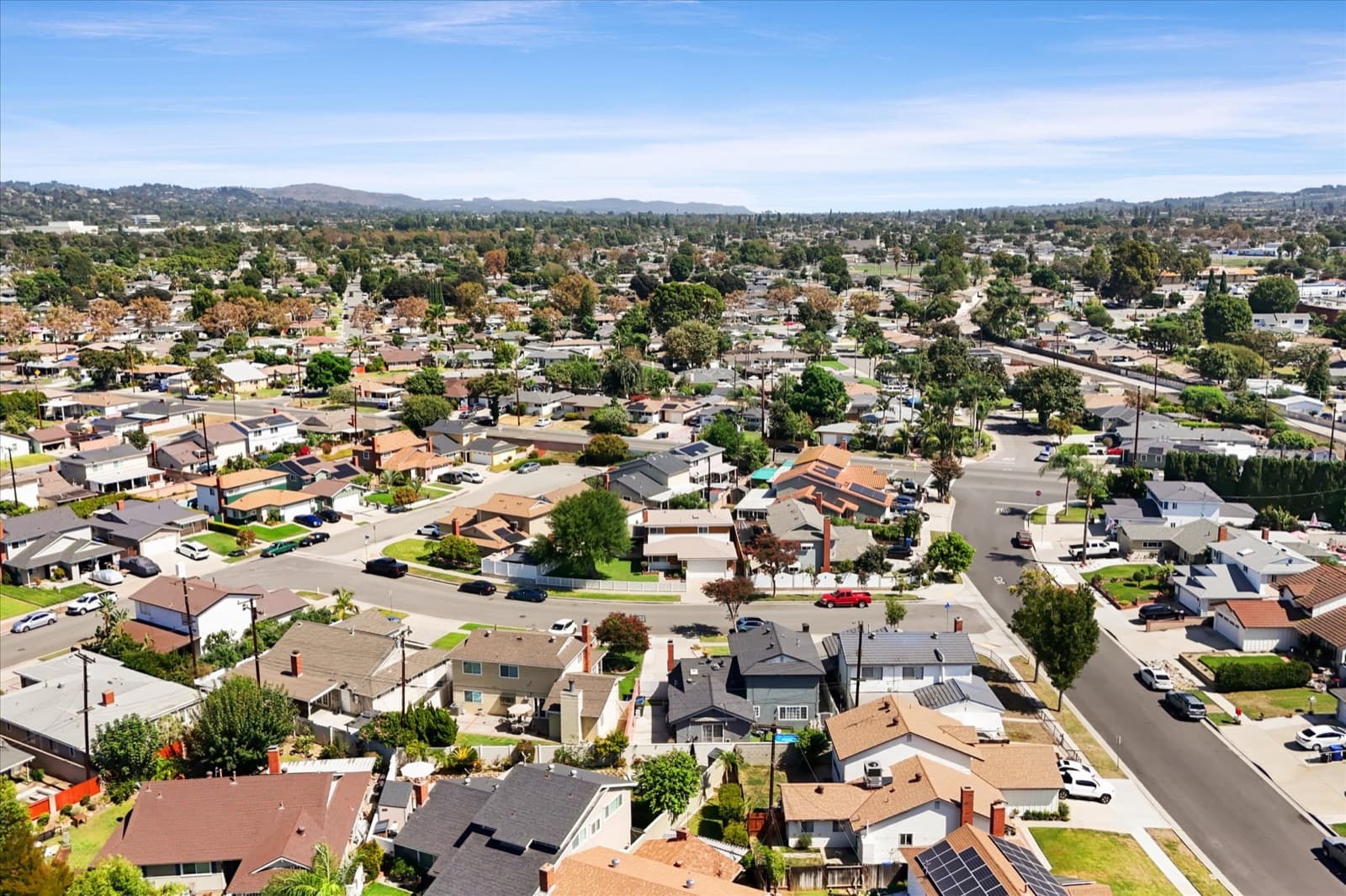 Aerial view over the surrounding South Whittier residential streets with hills along the horizon