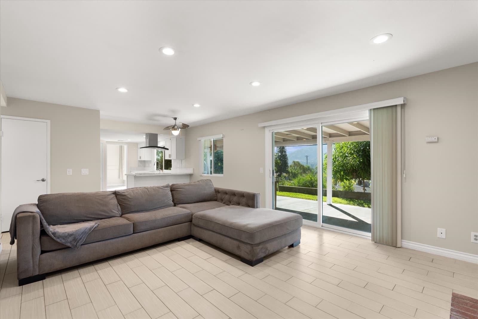 Family room with recessed lighting and sliding glass doors opening to the covered patio and backyard