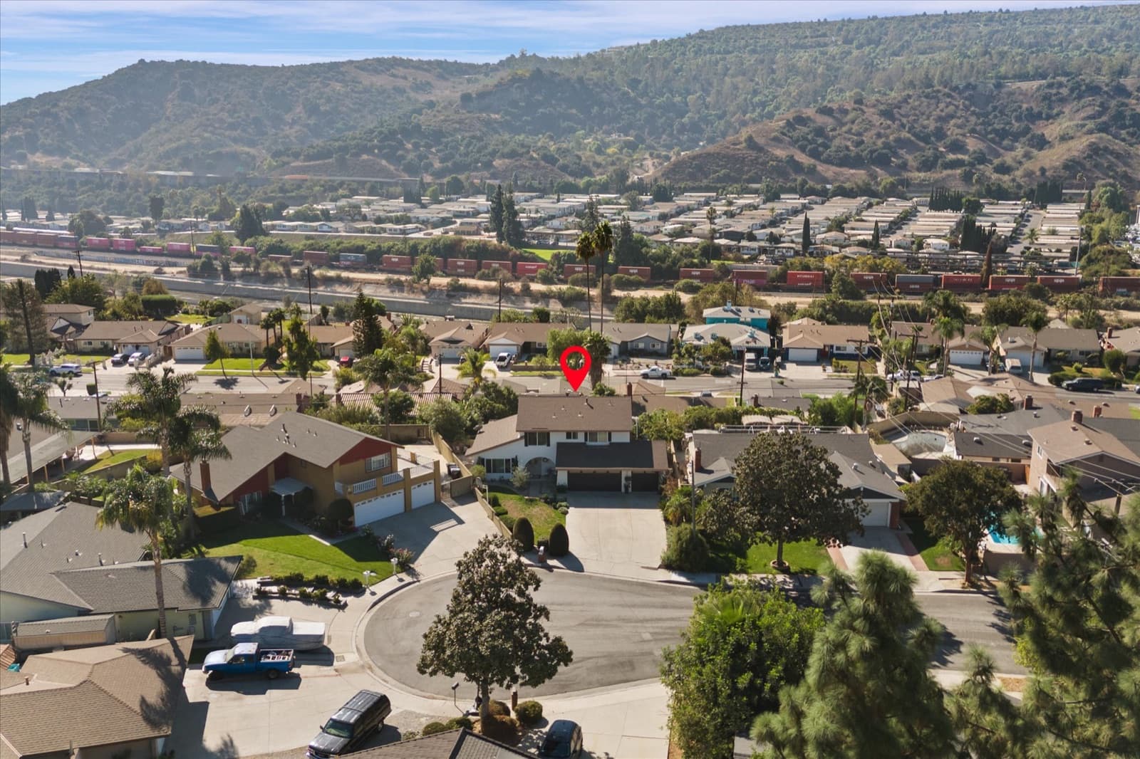 Neighborhood aerial with a map marker on the property, showing the cul-de-sac and the foothills beyond