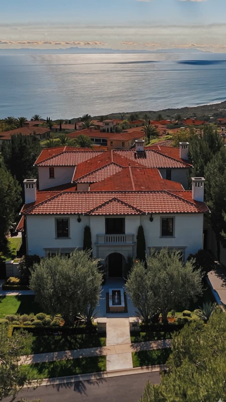 Vertical branding reel thumbnail of an aerial coastal estate with ocean views